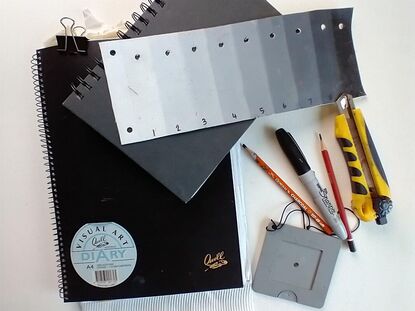 Picture of a Visual Diary, toner, pencils and viewfinder.